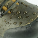 Close-up of a gray shoe with water droplets, emphasizing waterproof material.